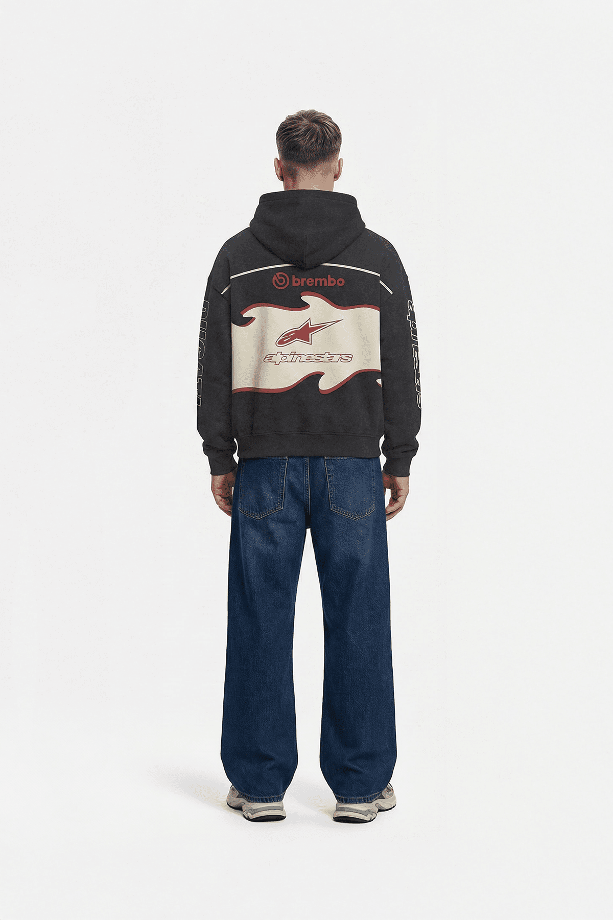 Black motorsport hoodie with Brembo and Alpinestars logos, back view from revnhaus