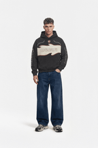 Black Ducati graphic hoodie with flame design and sleeve print, styled with jeans and sneakers from revnhaus