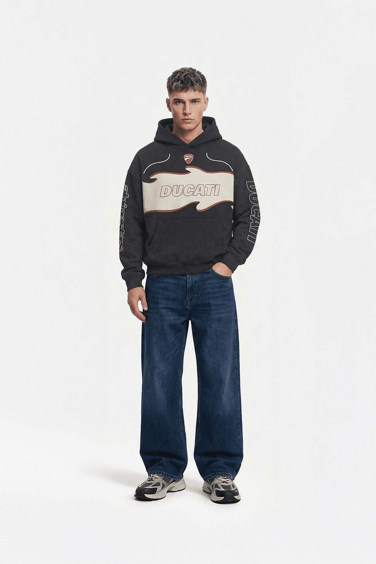 Black Ducati graphic hoodie with flame design and sleeve print, styled with jeans and sneakers from revnhaus