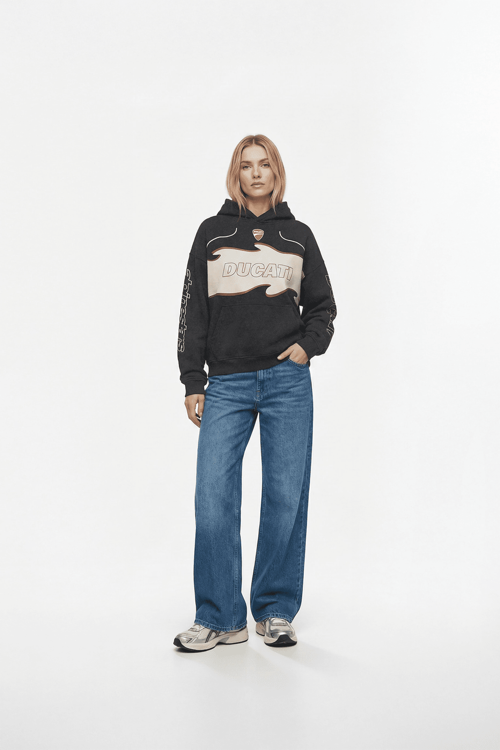 Black Ducati hoodie with flame graphic, worn with blue jeans and sneakers from revnhaus