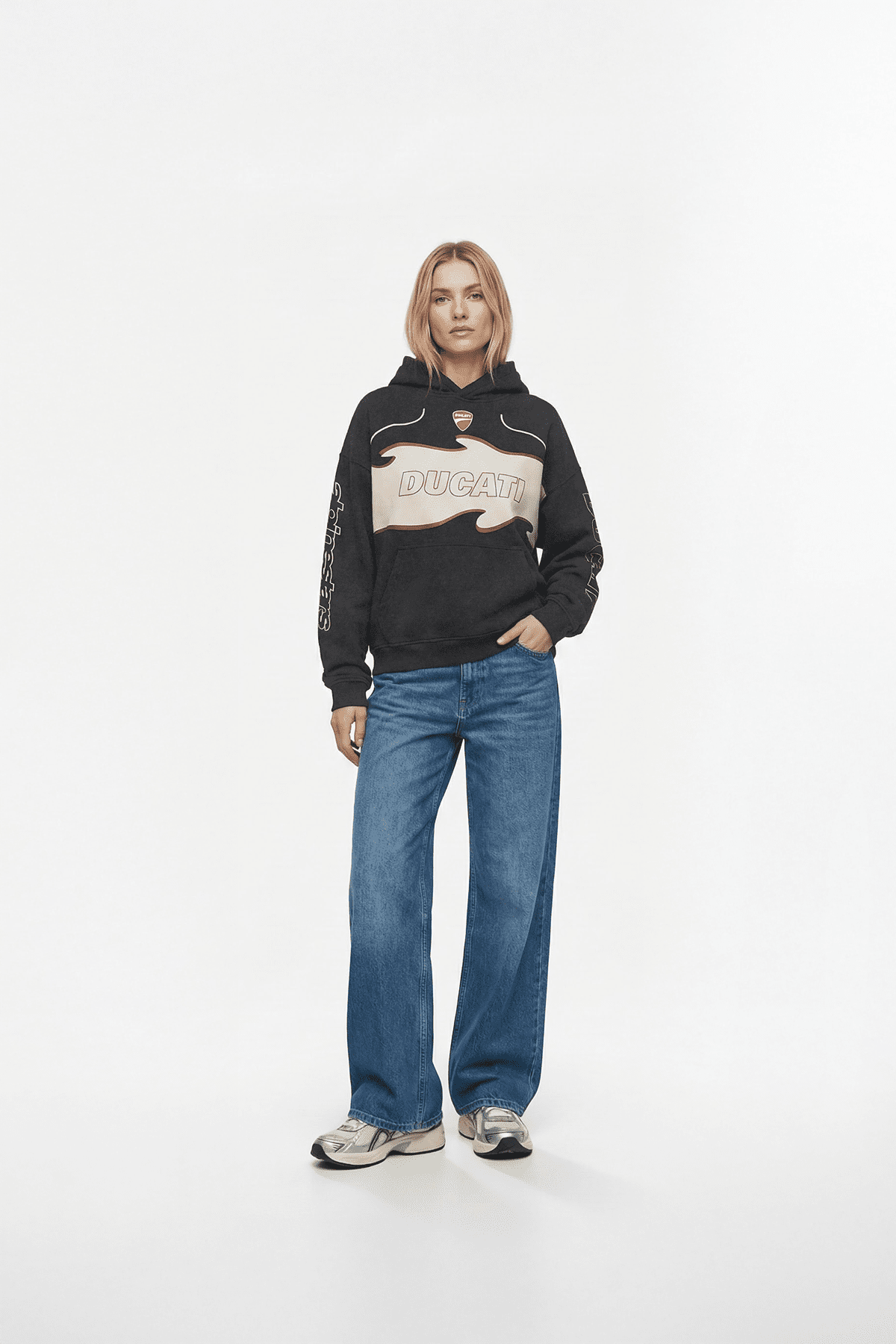 Black Ducati hoodie with flame graphic, worn with blue jeans and sneakers from revnhaus