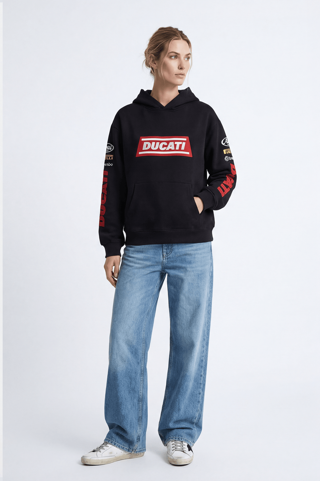 Black Ducati hoodie with red logo and sleeve graphics, styled with jeans and sneakers from revnhaus