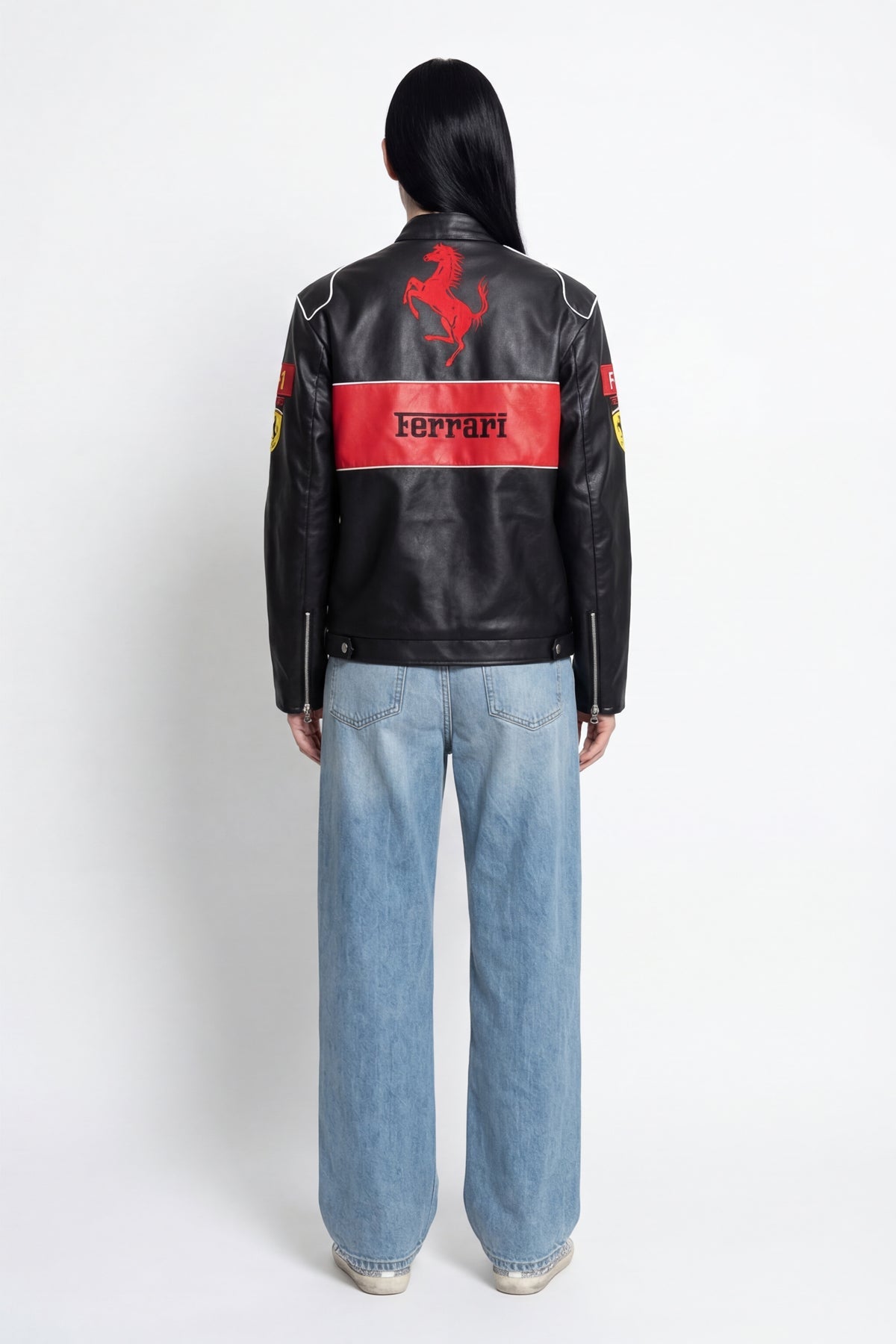 Black Ferrari racing jacket with red prancing horse logo and stripe, worn with jeans from revnhaus