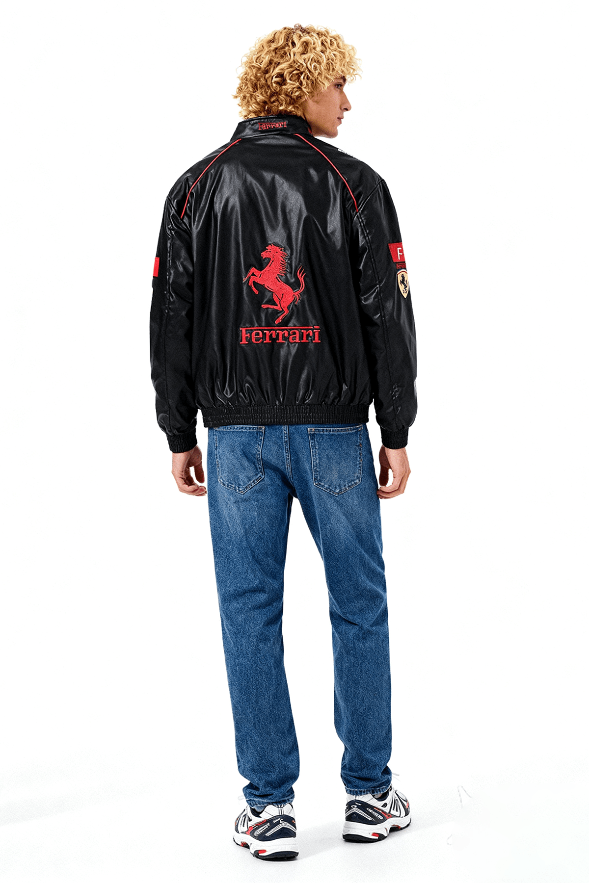 Black Ferrari racing jacket with red prancing horse logo, worn with jeans from revnhaus