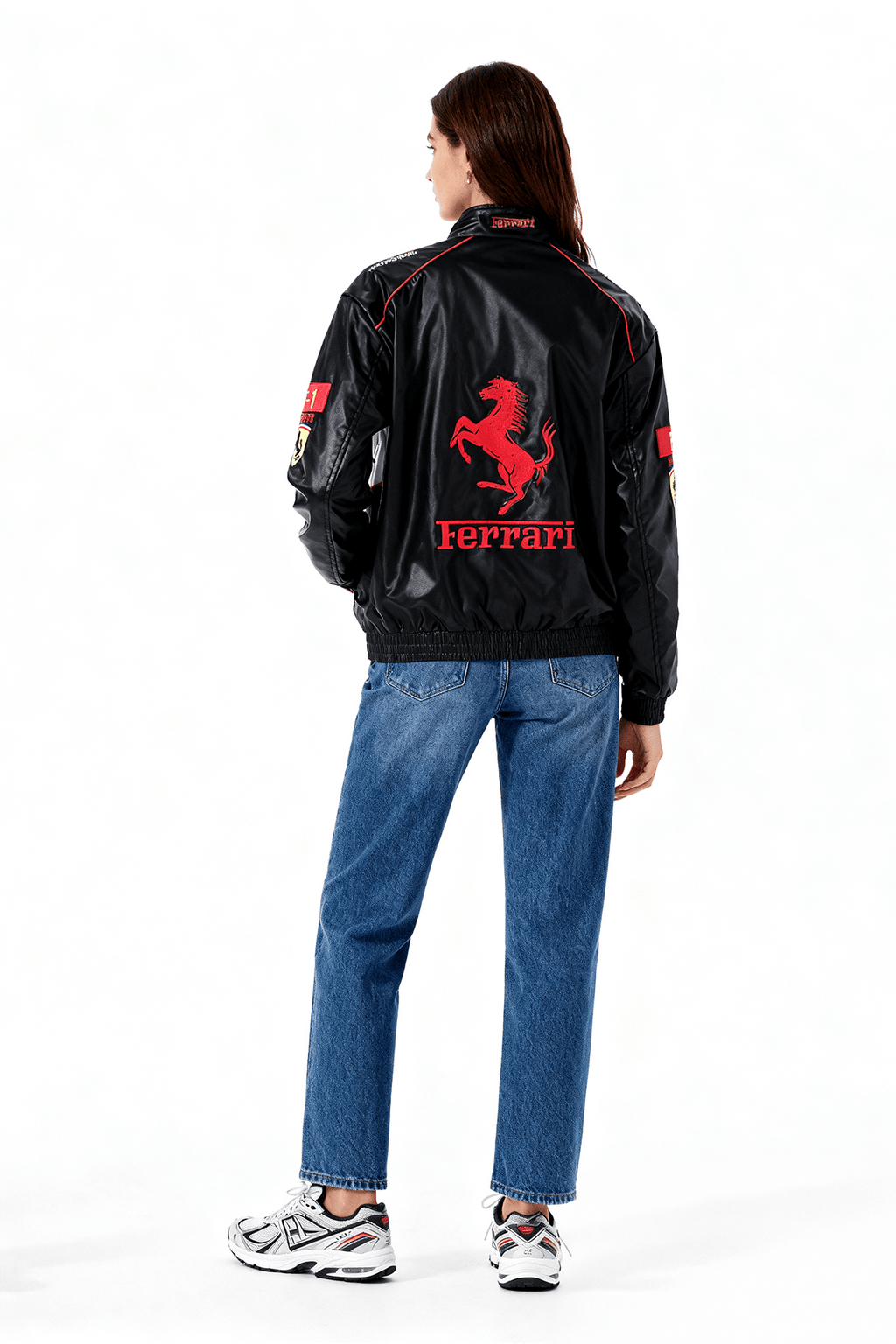 Black Ferrari racing jacket with red prancing horse logo, worn by woman in jeans from revnhaus