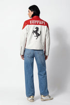 Red and white Ferrari racing jacket with prancing horse logo, worn with jeans from revnhaus