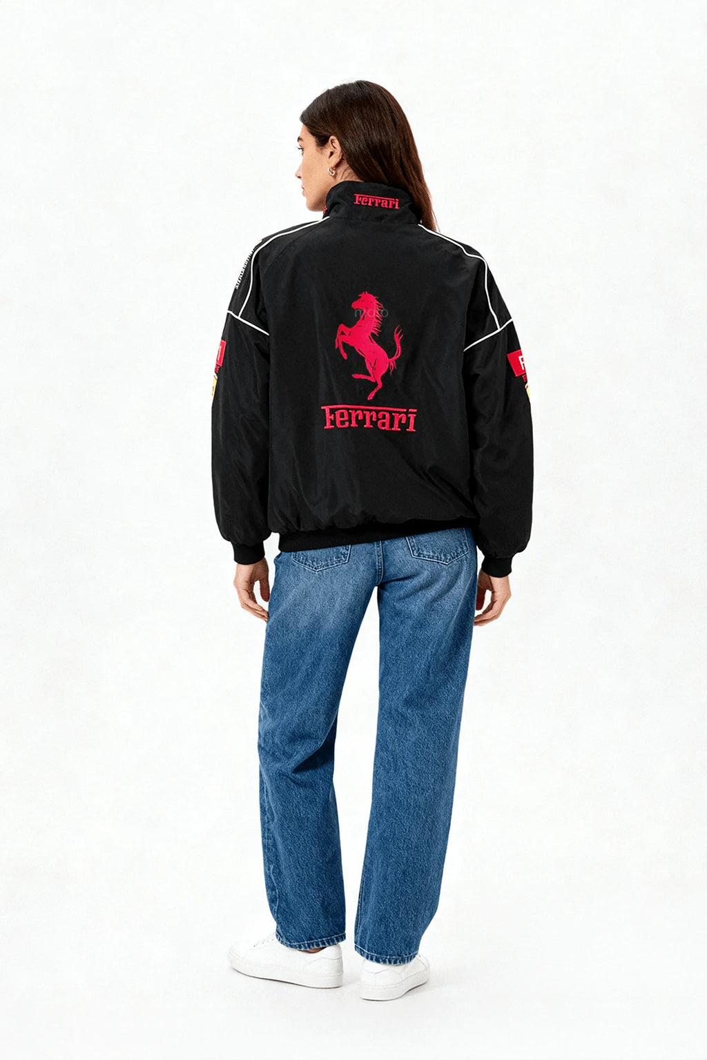 Black Ferrari racing jacket with red prancing horse logo, worn with blue jeans from revnhaus