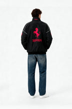 Black Ferrari racing jacket with red prancing horse logo, worn with jeans from revnhaus