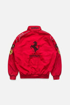 Red Ferrari racing jacket with prancing horse logo and sponsor patches from revnhaus