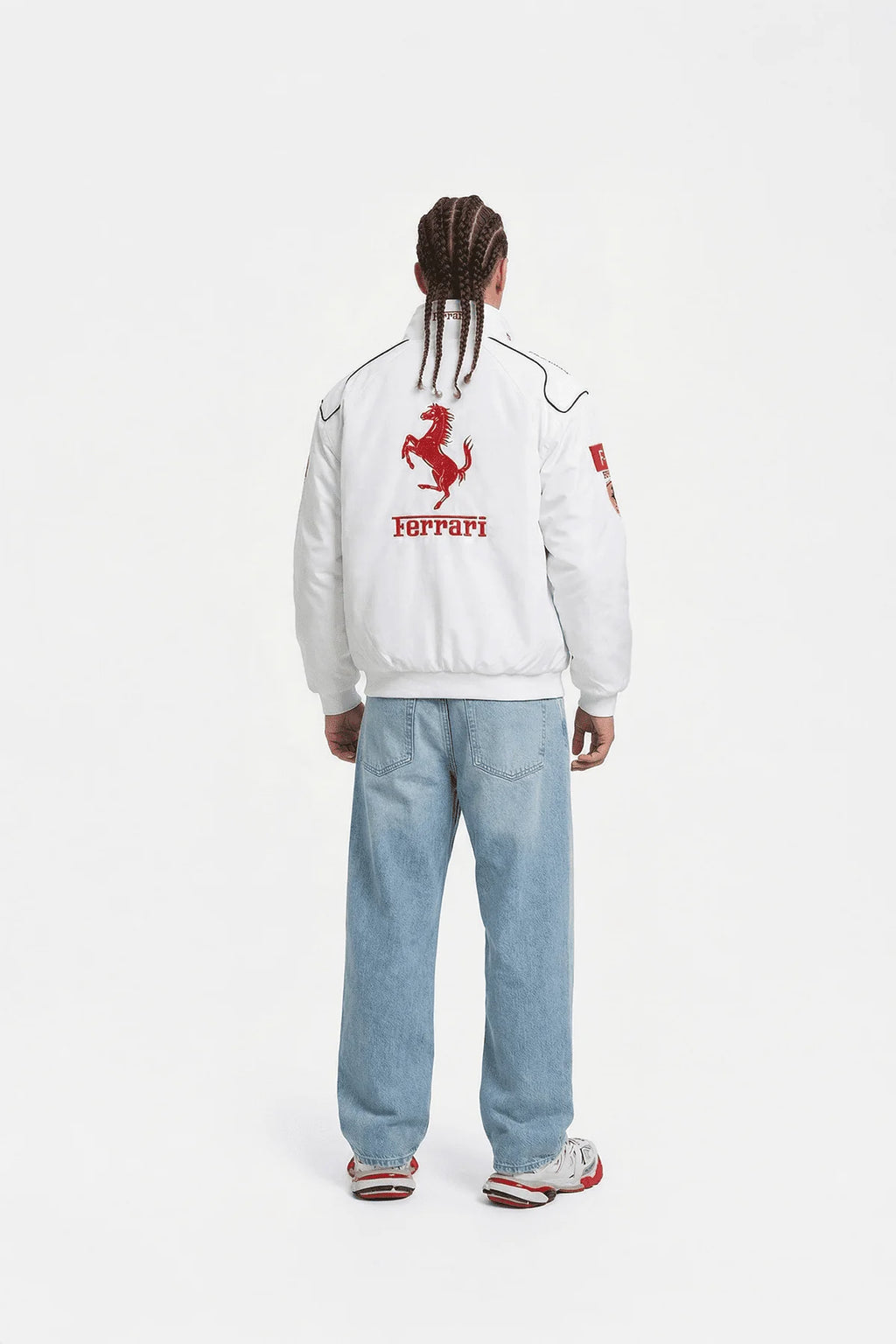 White Ferrari racing jacket with red prancing horse logo, worn with light denim jeans from revnhaus