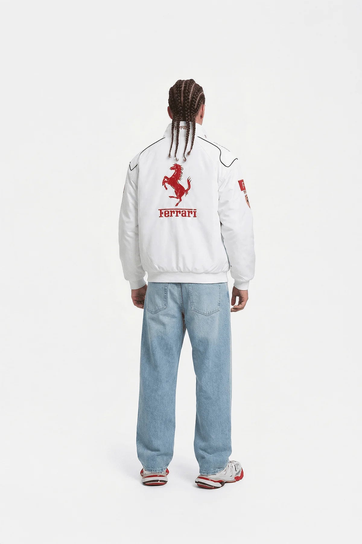 White Ferrari racing jacket with red prancing horse logo, worn with light denim jeans from revnhaus