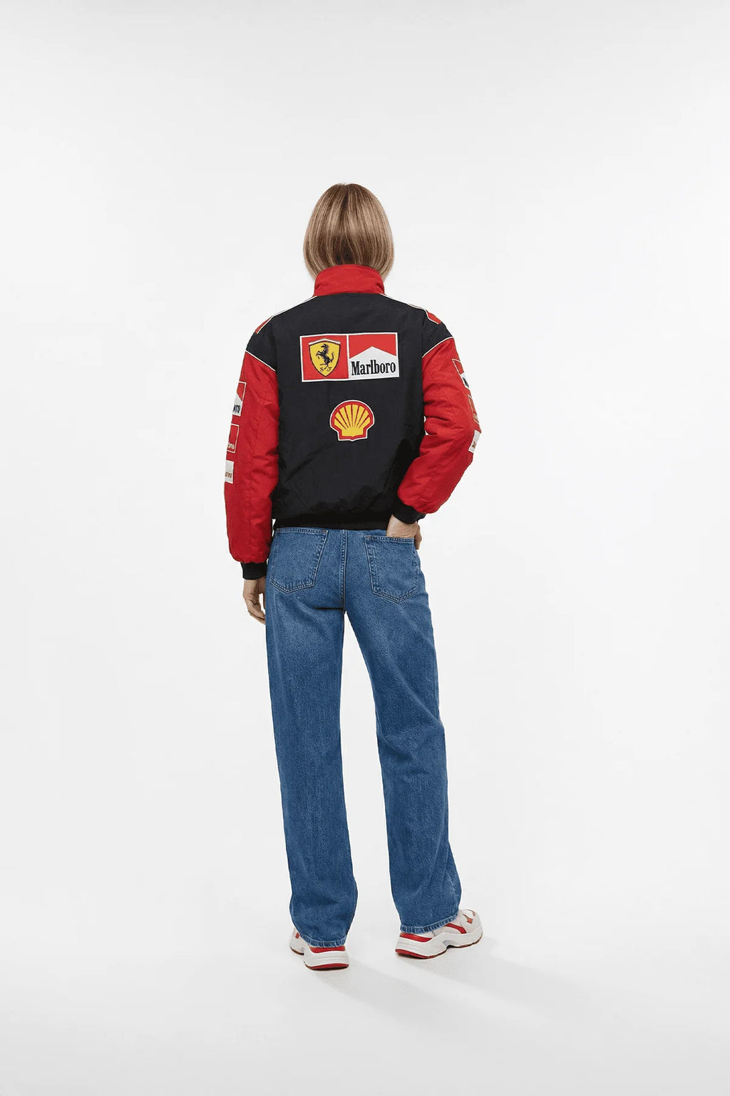 Ferrari F1 racing jacket with Marlboro and Shell logos, worn with jeans from revnhaus