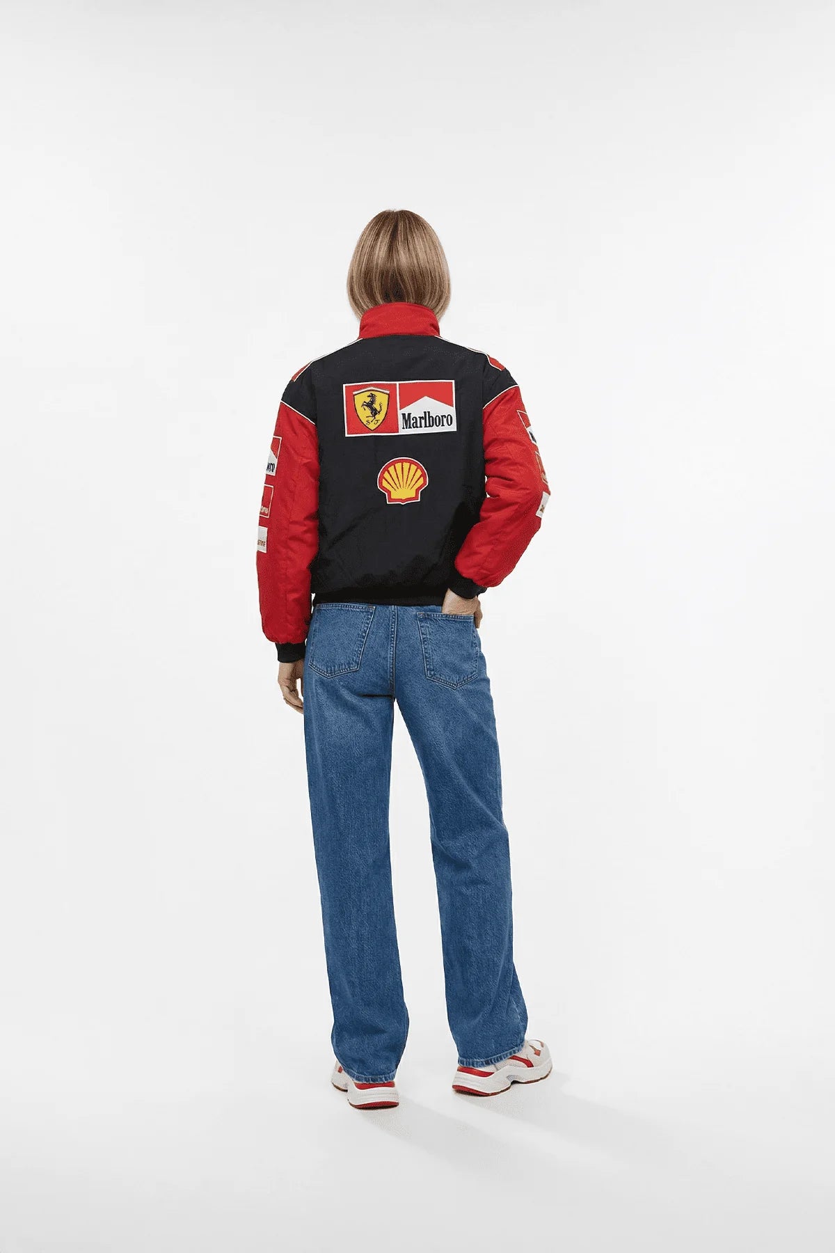 Ferrari F1 racing jacket with Marlboro and Shell logos, worn with jeans from revnhaus
