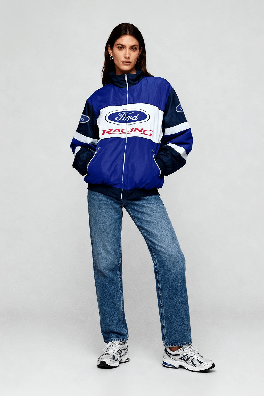 Blue Ford Racing motorsport jacket with white stripes, worn with jeans and sneakers from revnhaus