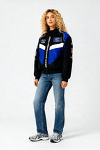 Ford Performance Racing jacket with blue and black design, worn by woman in jeans from revnhaus