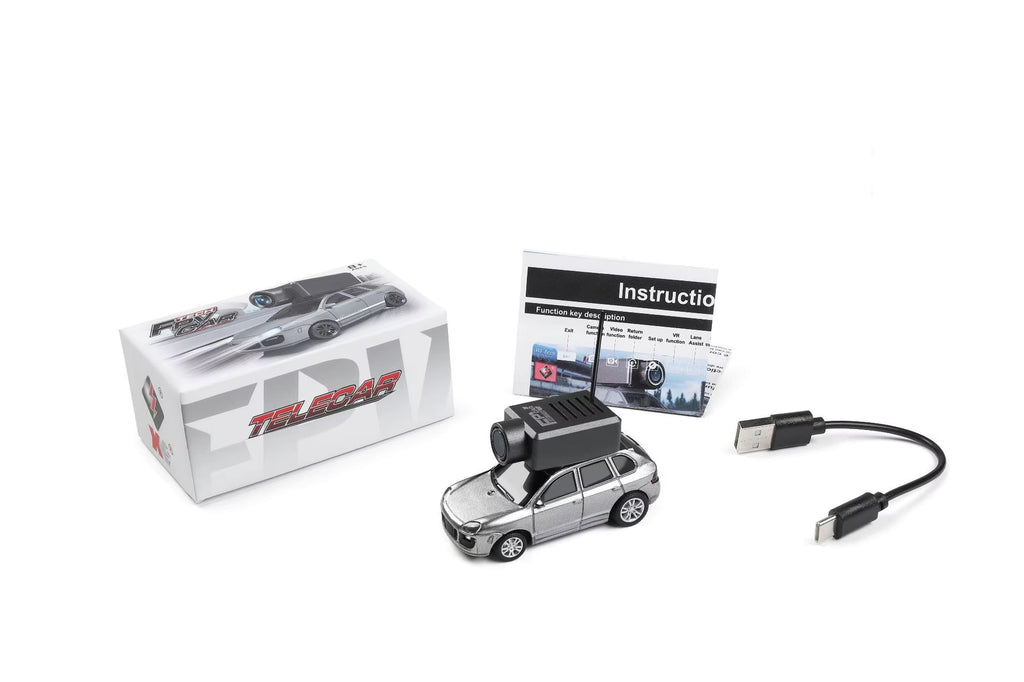 Silver RC drift car with camera, USB cable, and instruction manual from revnhaus