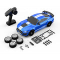 Blue RC drift car with remote, spare tires, and tools for assembly from revnhaus