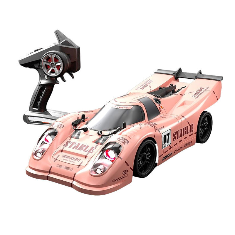 Pink RC drift car with remote control, racing decals, and glowing headlights from revnhaus