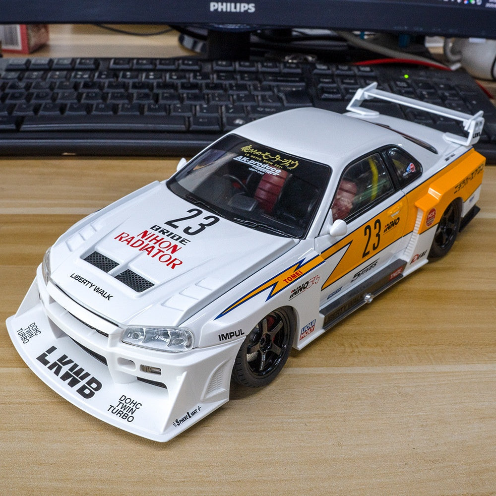 White and orange RC drift car with racing decals and number 23, from revnhaus