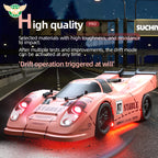 Pink RC drift car with glowing red lights and 'STABLE' decals on racetrack at night from revnhaus