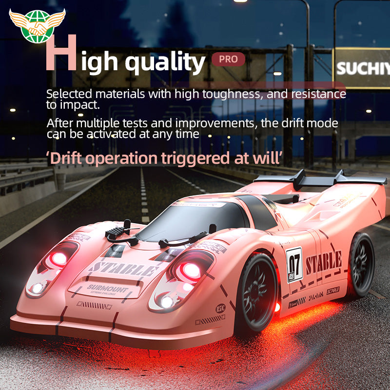 Pink RC drift car with glowing red lights and 'STABLE' decals on racetrack at night from revnhaus