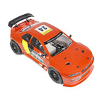 Orange RC drift car with racing decals and rear wing from revnhaus