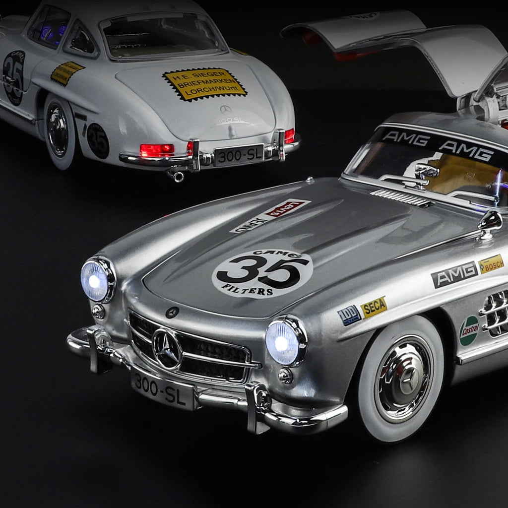 Silver Mercedes 300 SL die-cast model with racing decals, open gullwing door, from revnhaus