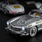 Silver Mercedes 300 SL die-cast model with racing decals, open gullwing door, from revnhaus