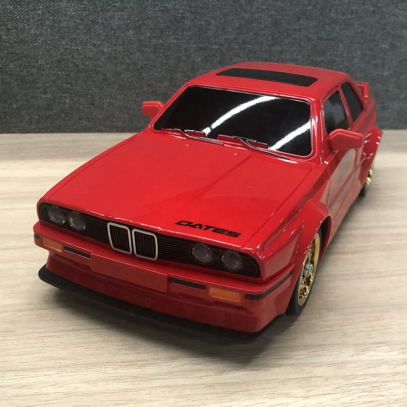 Red BMW E30 M3 die-cast model car with gold wheels and DATES decal from revnhaus