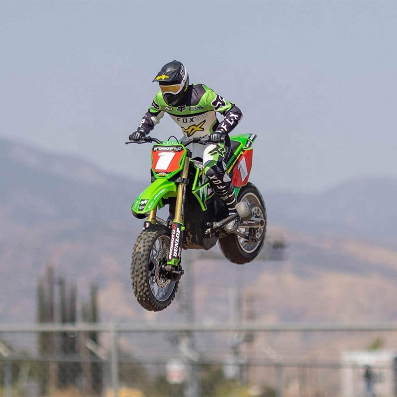 RC motocross rider mid-air on green dirt bike with Fox gear from revnhaus