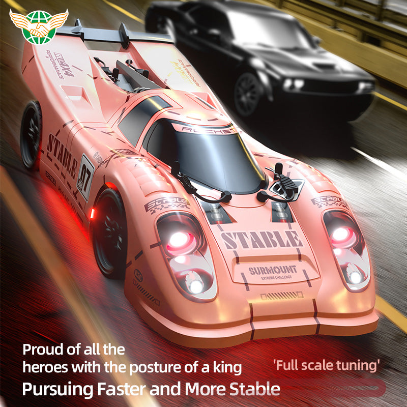 Pink RC drift car with 'STABLE' livery racing on track, glowing red lights, from revnhaus