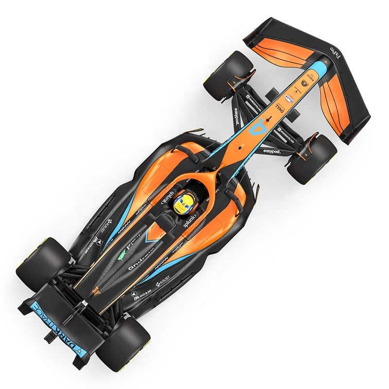 Orange and black Formula 1 race car with blue accents, top view, from revnhaus