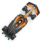 Orange and black Formula 1 race car with blue accents, top view, from revnhaus