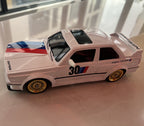 White BMW M3 die-cast model with gold wheels, racing stripes, and #30 livery from revnhaus