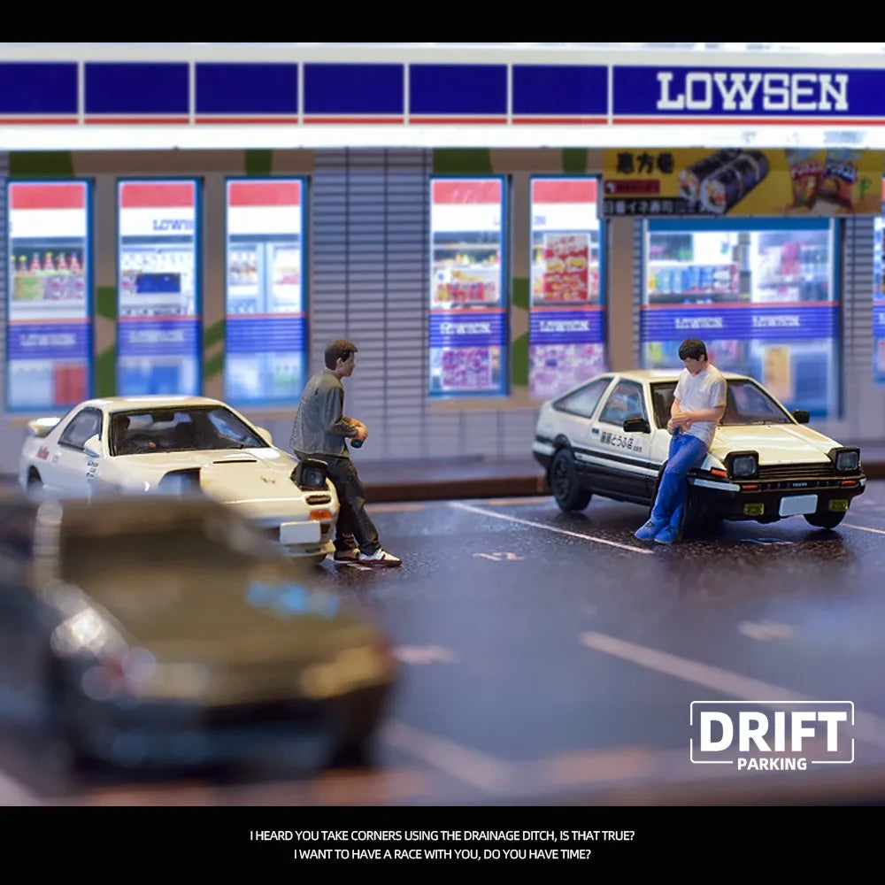 Die-cast drift car models with figures at LowSen convenience store scene from revnhaus