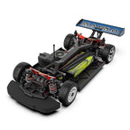 RC drift car with exposed chassis, red suspension, and RLAARLO wing from revnhaus