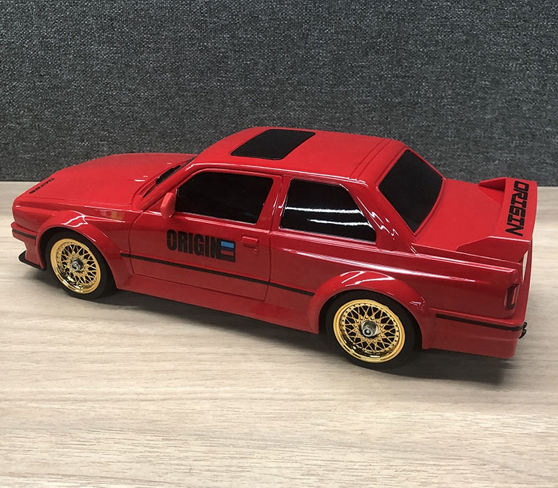 Red die-cast drift car with gold wheels and ORIGIN decals from revnhaus