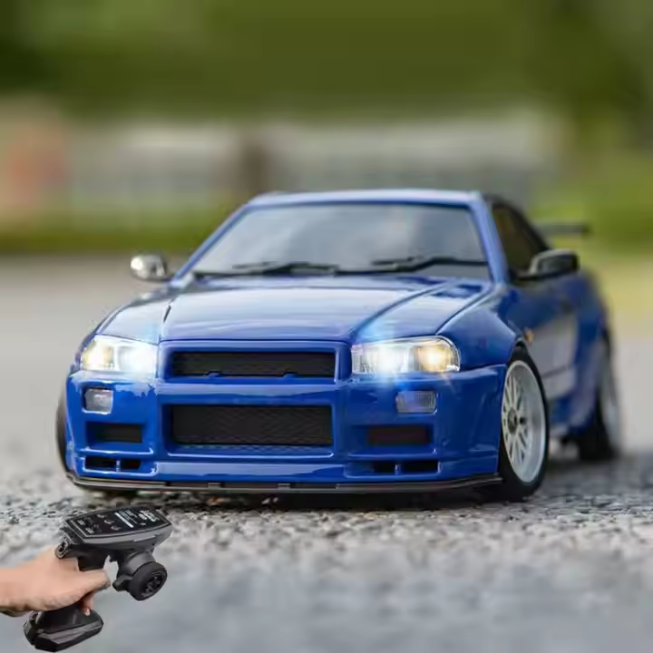 Blue RC drift car with remote control, headlights on, from revnhaus