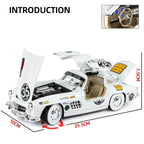 White Mercedes 300 SL die-cast model car with open doors, hood, and detailed interior from revnhaus