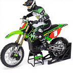 Green RC motocross bike with rider in Fox gear on stand from revnhaus