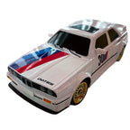 White BMW E30 M3 die-cast model with blue red stripes, gold wheels, and '30' racing number from revnhaus