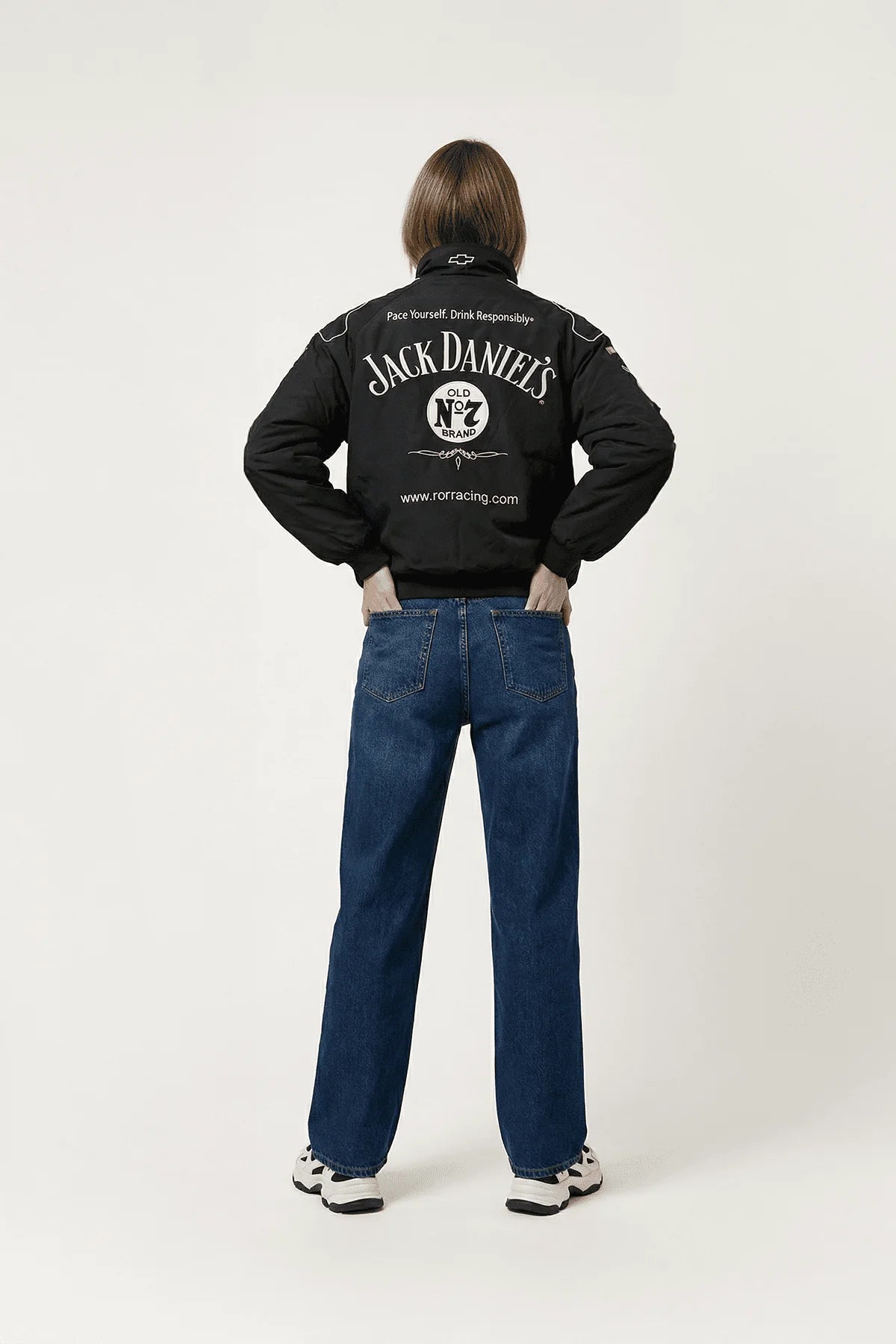 Black Jack Daniel's racing jacket with bold logo, worn with jeans and sneakers from revnhaus