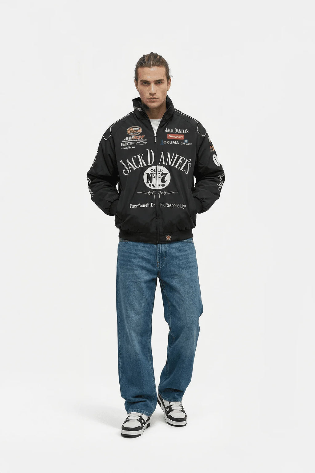 Jack Daniel's racing jacket with sponsor logos, worn with jeans and sneakers from revnhaus