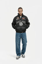 Jack Daniel's racing jacket with sponsor logos, worn with jeans and sneakers from revnhaus