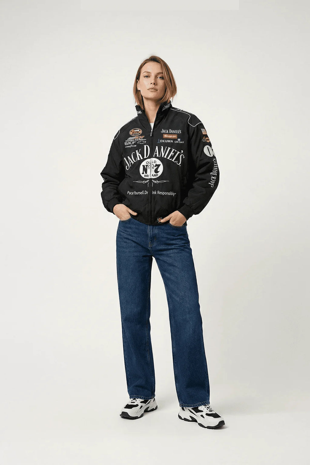 Jack Daniel's racing jacket with sponsor logos, worn with jeans and sneakers from revnhaus