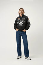 Jack Daniel's racing jacket with sponsor logos, worn with jeans and sneakers from revnhaus