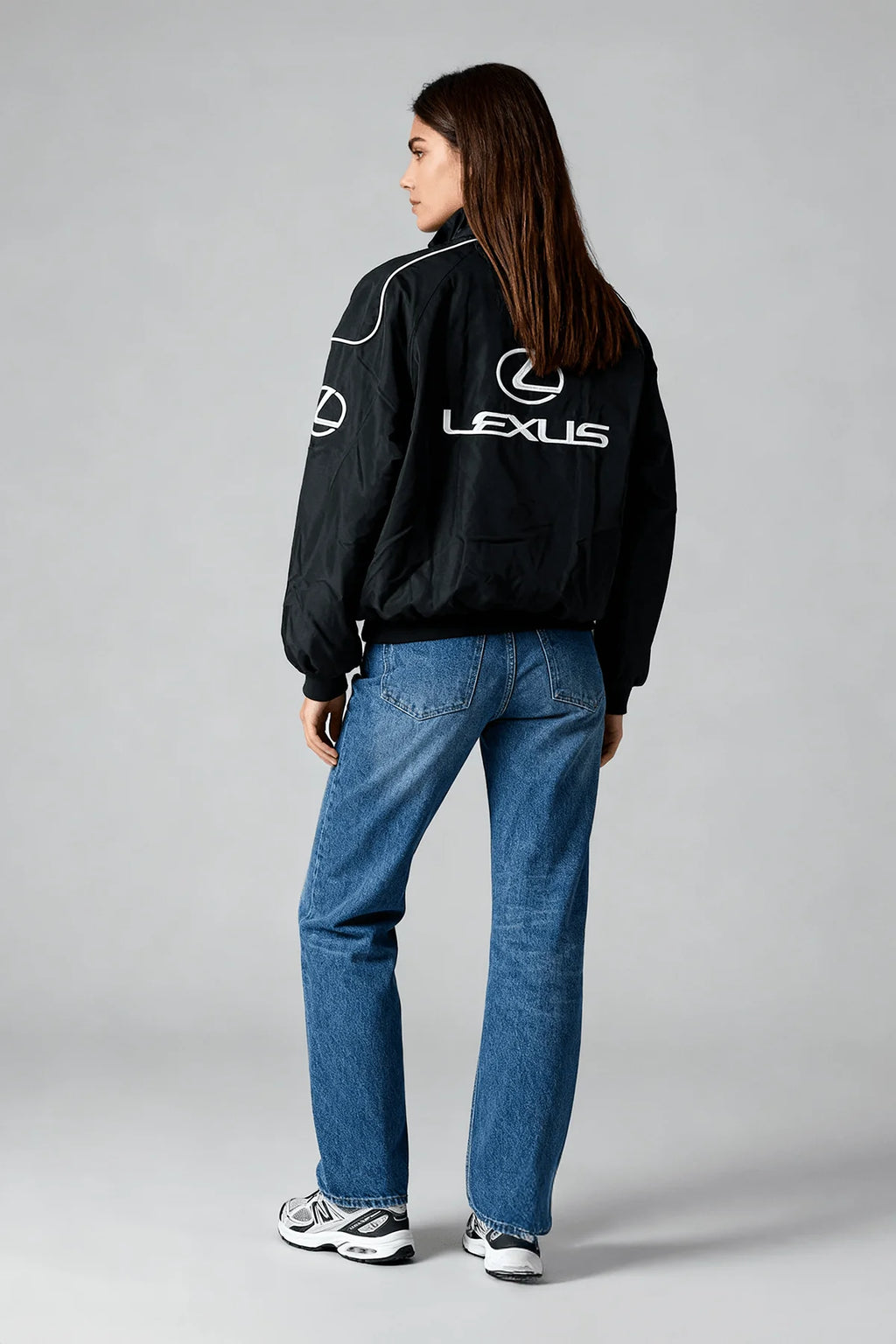 Black Lexus racing jacket with white logo, worn with blue jeans and sneakers from revnhaus