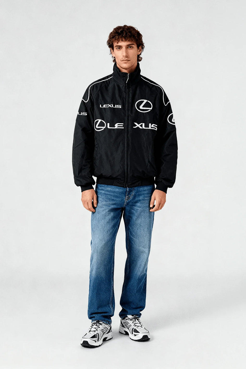 Black Lexus racing jacket with white logos, worn with jeans and sneakers from revnhaus
