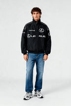 Black Lexus racing jacket with white logos, worn with jeans and sneakers from revnhaus