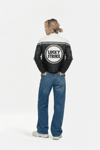 Black and white Lucky Strike racing jacket with bold logo, worn with jeans from revnhaus